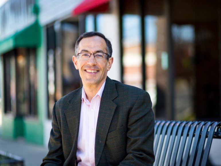 Ed Lazere sits on a bench