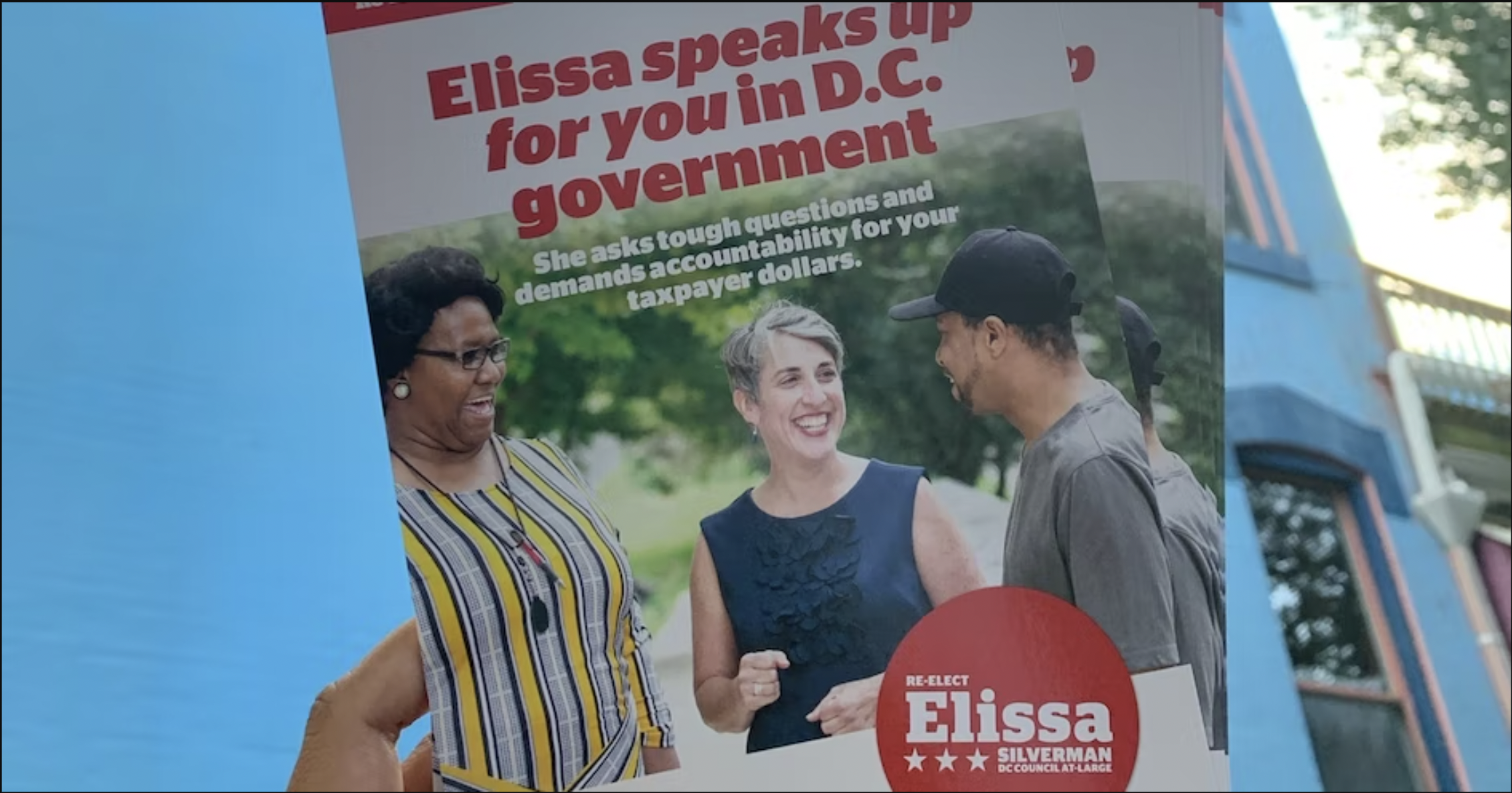 A hand holding Elissa Silverman for DC Council flyers